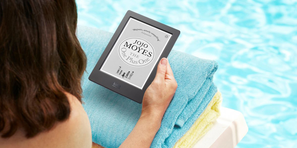 Woman reading e-reader by the pool