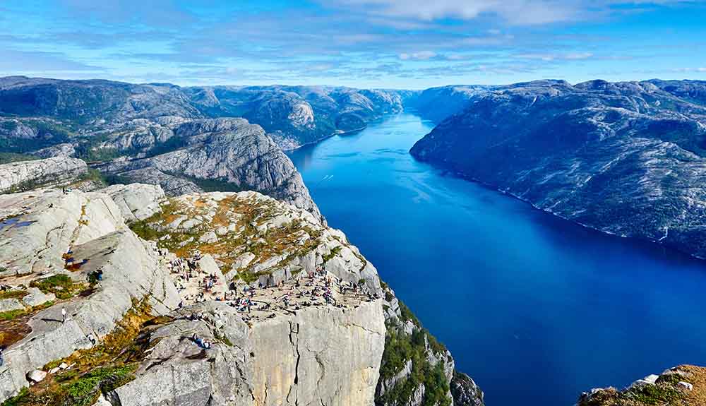 Gorgeous landscape shot of rocky cliffs looking over a still blue lake at a US National Park 