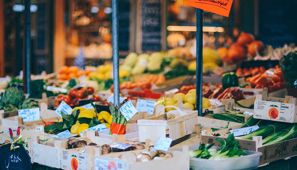 Produce market display in front of a cute foreign store