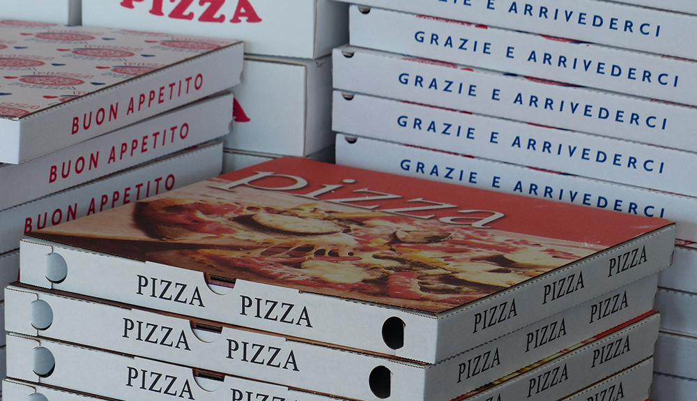 Four stacks of pizza boxes are shown