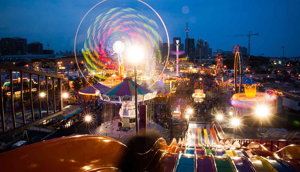 The CNE midway with bright colourful lights at night