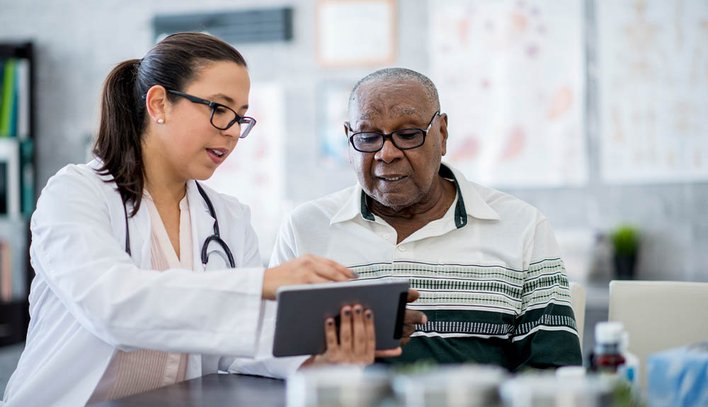 Doctor reviewing chart with older man