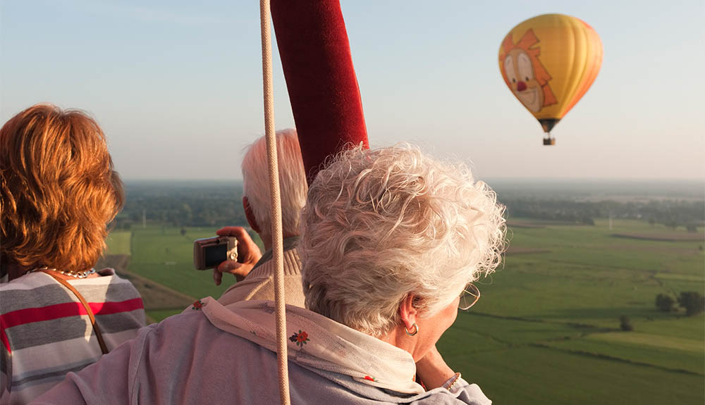 Older couple riding in a hot-air balloon