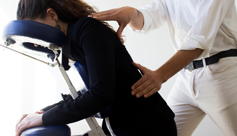 Person getting back rub in massage chair