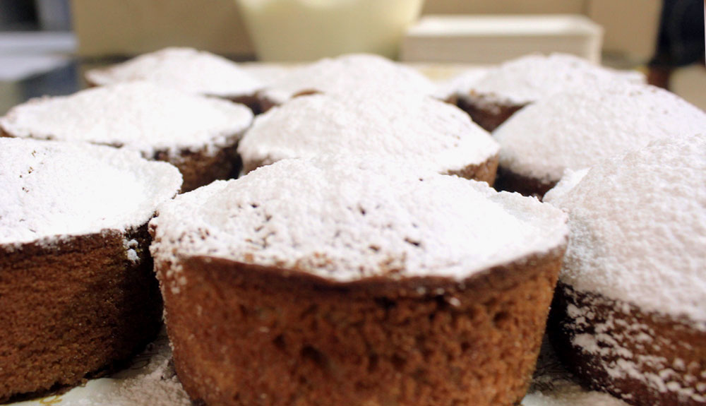 Close up of baked goods powdered in icing sugar