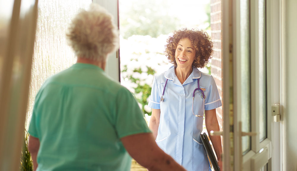 Person opening door to smiling doctor