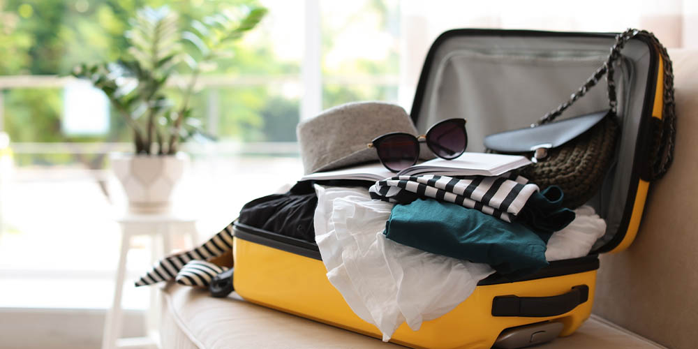 An overstuffed suitcase is shown