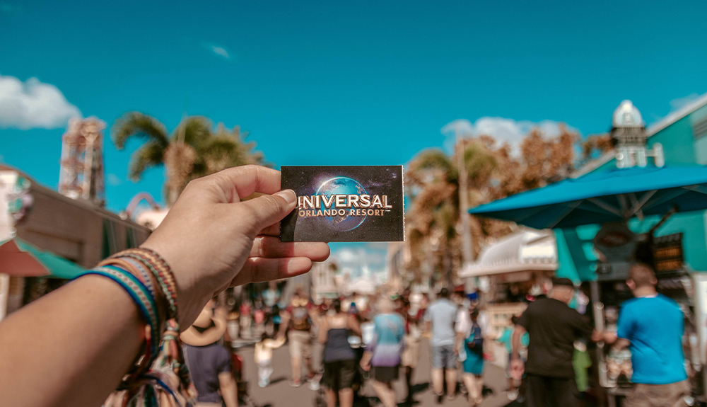 A visitor holds up a card that says Universal Orlando Resort, in Orlando, Florida
