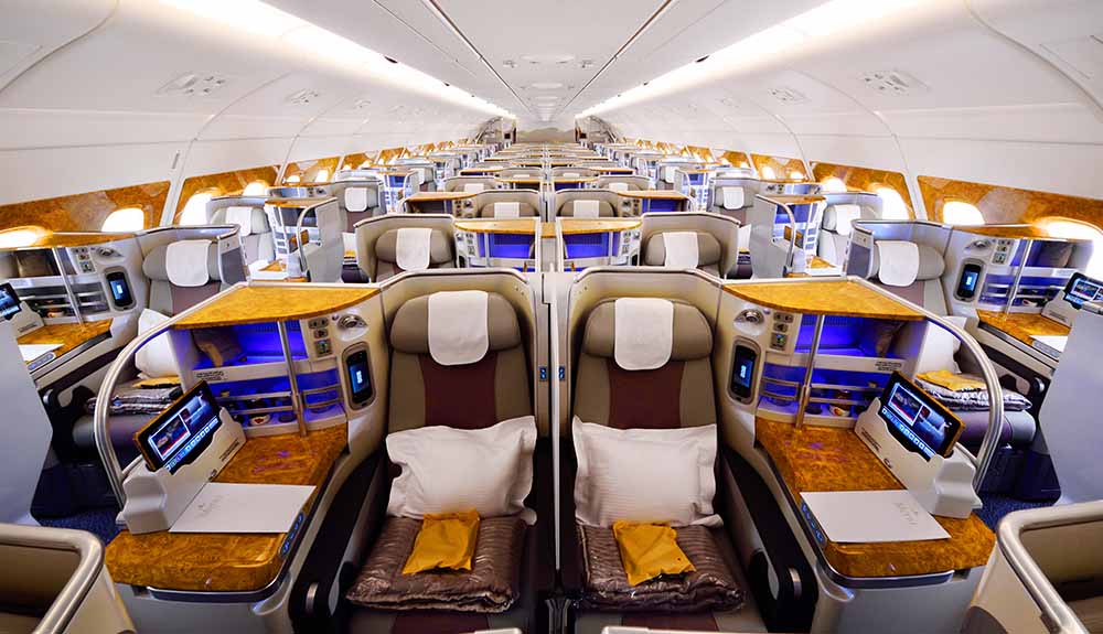 Luxurious seating pods complete with soft leather seats, wood rest and personal iPads on Emirates flights