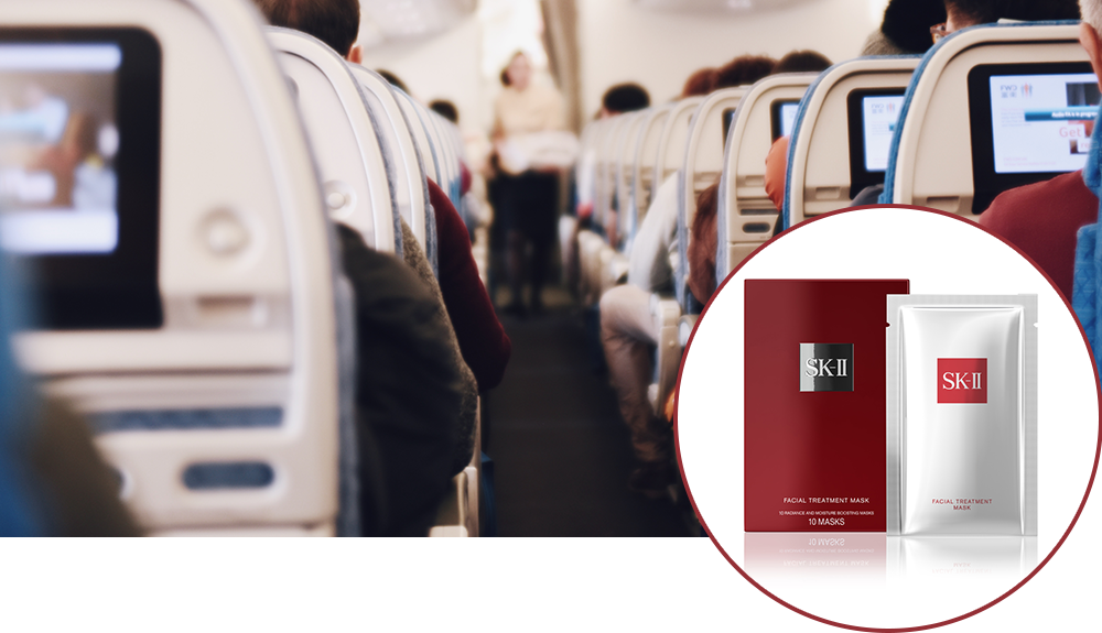 Product shot of sheet masks over a photograph of the aisles of a full airplane