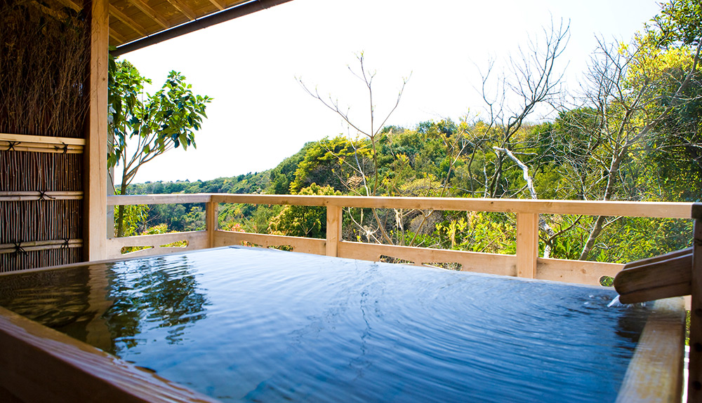 A Japanese bath looks out at forest view