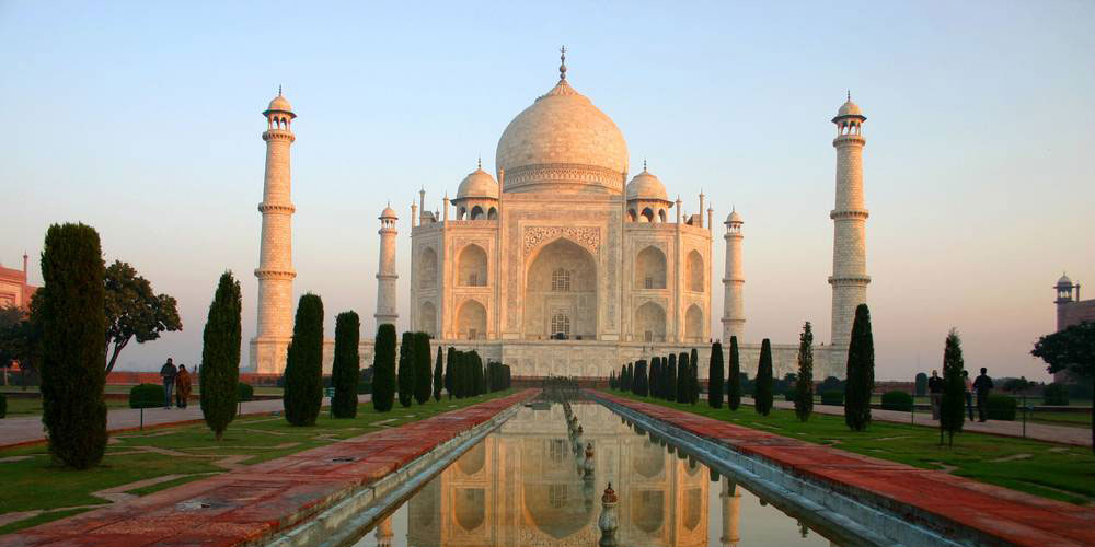 Beautiful shot of the Taj Mahal seen from behind the pond, the building reflected in the still waters