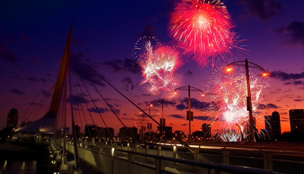 Red fireworks burst in the sky over Winnipeg, Manitoba