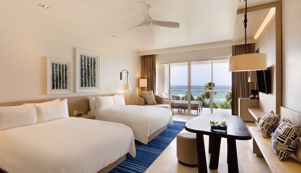 Simple and clean Hyatt hotel room with two queen size beds and a seating area