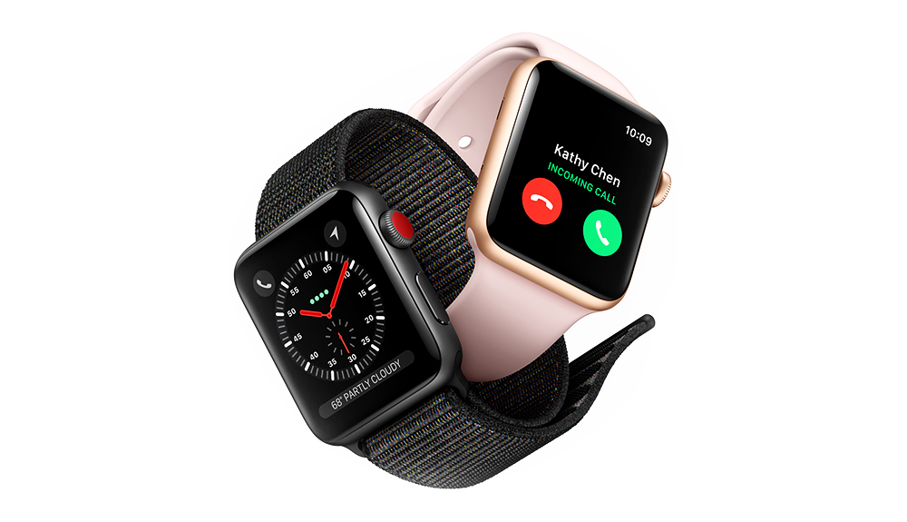 An Apple watch on a black band set to the clock and an Apple watch on a rose gold band displaying a phone call