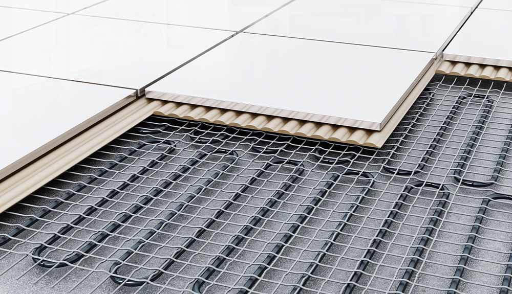 Tiles removed from a floor show the radiant heating coils underneath.