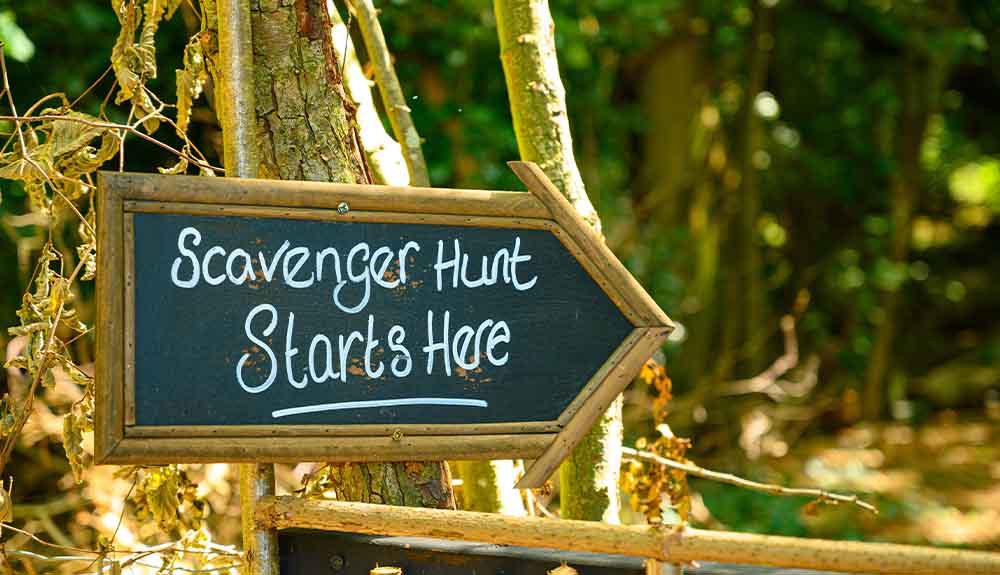 A chalkboard shaped like an arrow reads "Scavenger Hunt Starts Here"