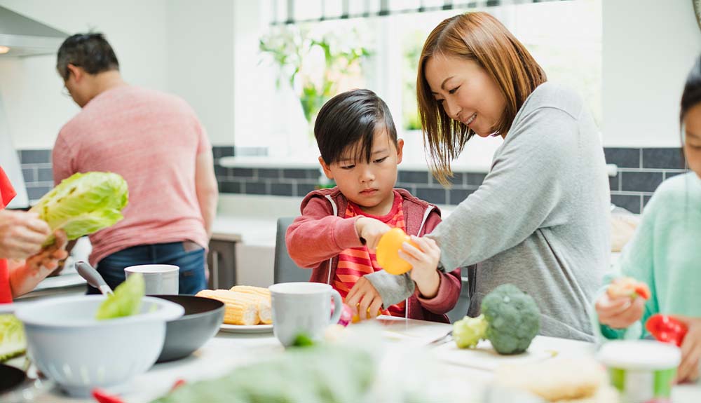 A family prepares a meal together in the kitchen