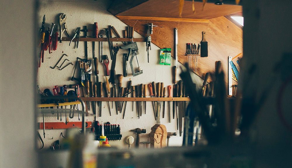 A neat garage with tools mounted to the wall