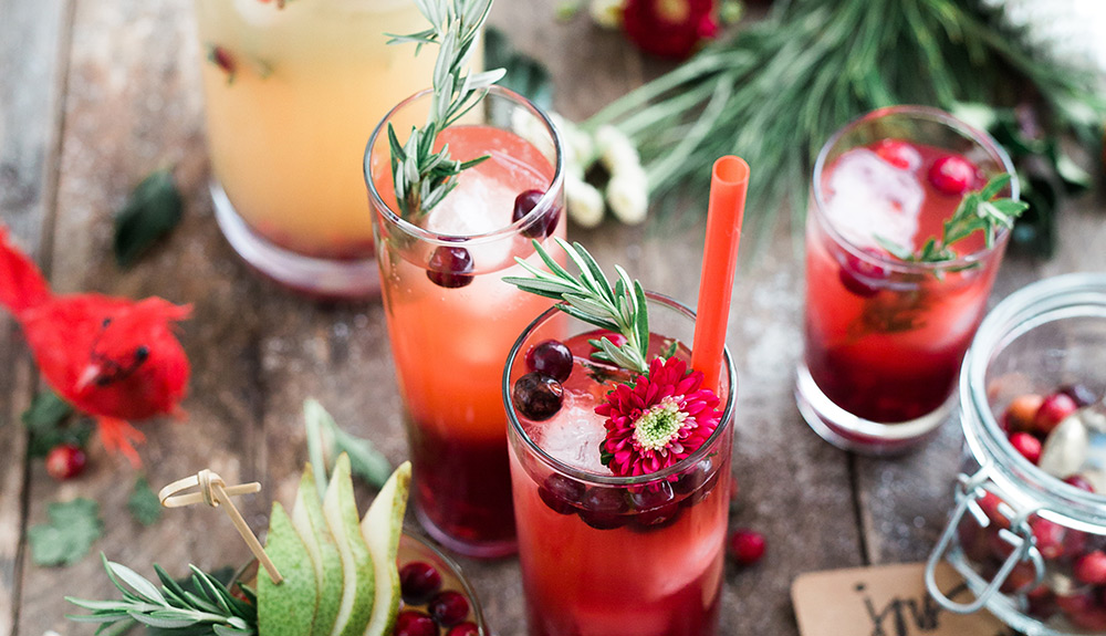 Cranberry holiday cocktails on a wooden table