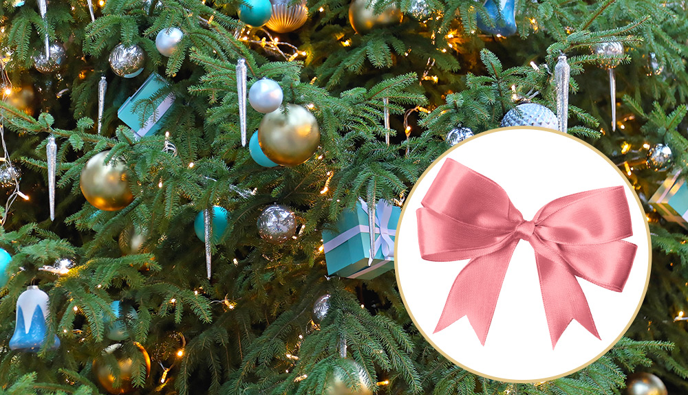 Closeup of a tree with blue and gold ornaments
