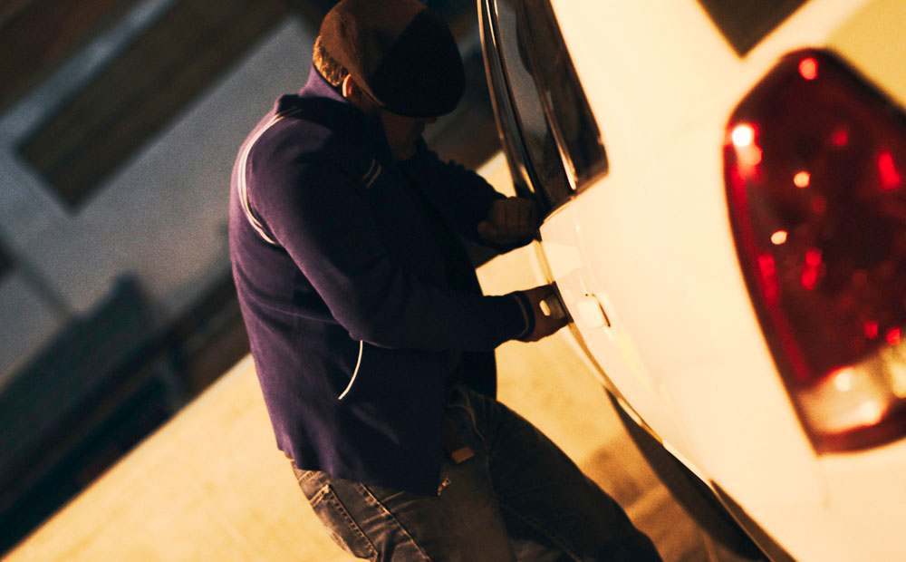 Car thief breaking into a car