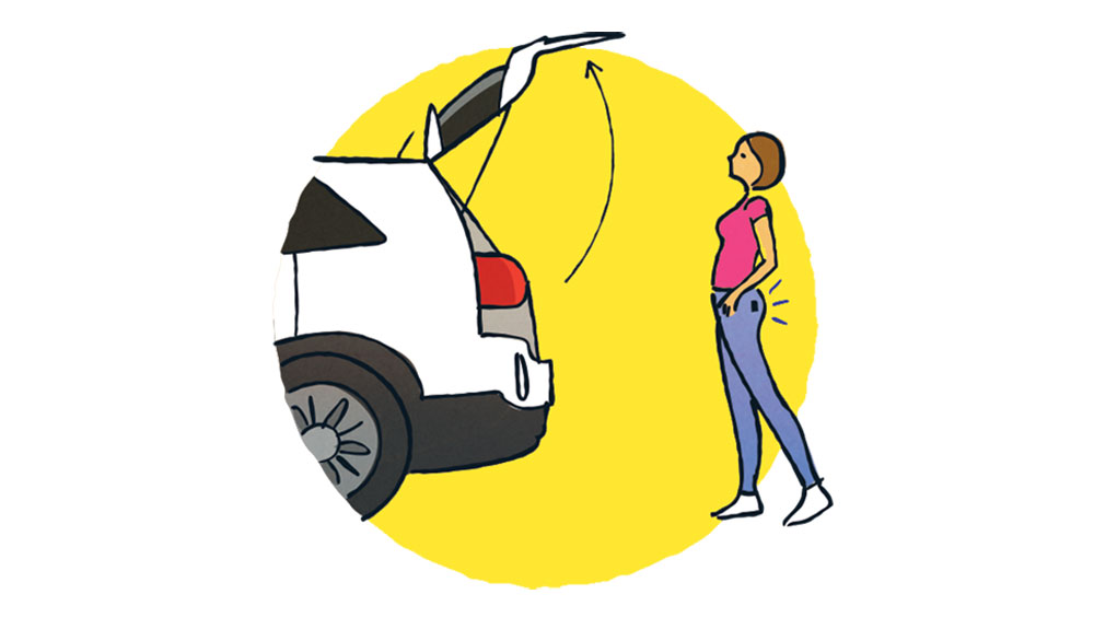 An illustration shows a woman standing behind her SUV with the tailgate open