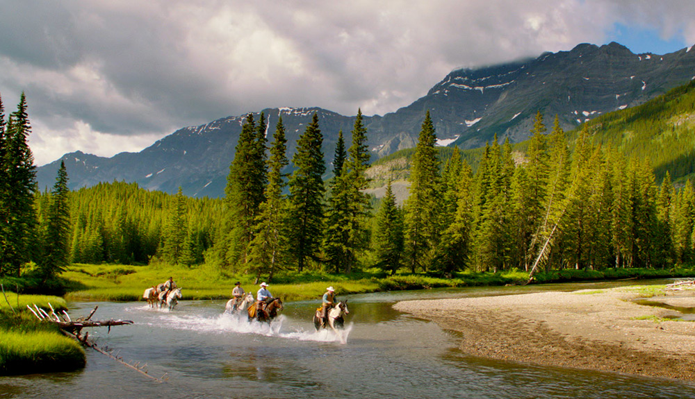 Horseback riding in a mountain stream