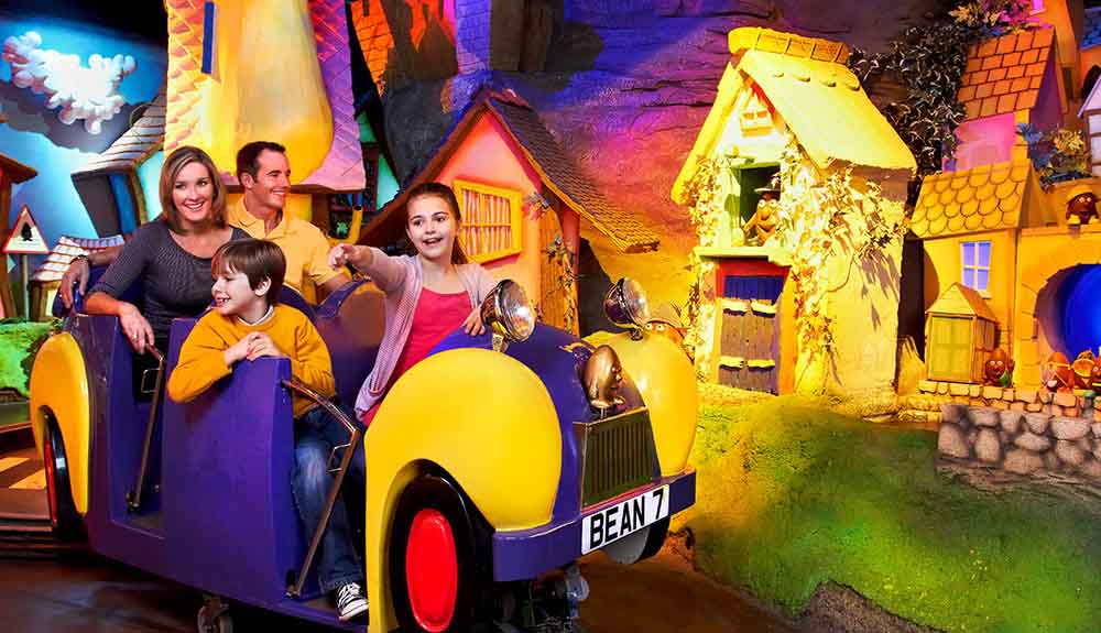 A family rides a whimsical and colourful rise at Cadbury World in Birmingham, England