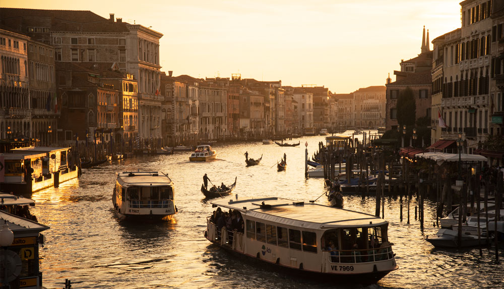 The busy canals in Venice, Italy are seen at sunset