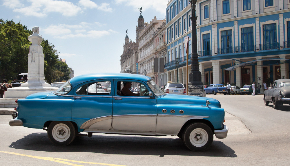A classic blue vintage car is seen on the streets of Old Havana