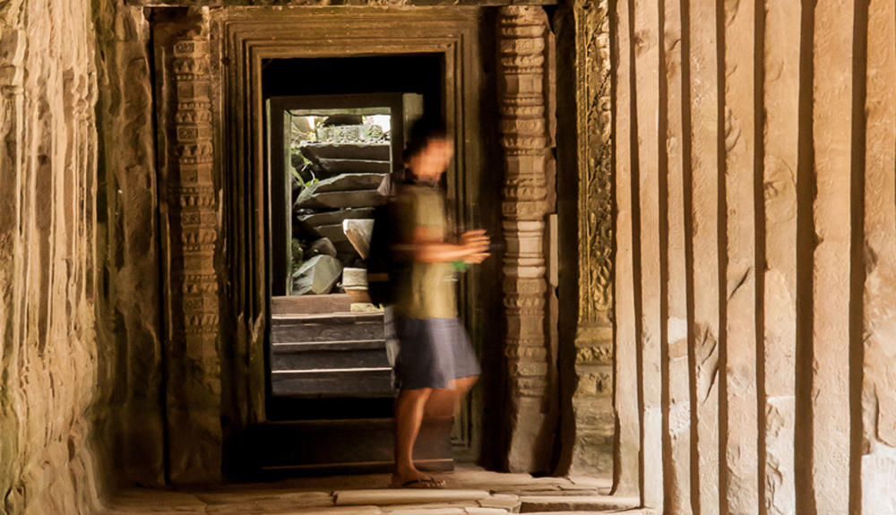 Blurred man in a corridor in the temple of Ta Prohm