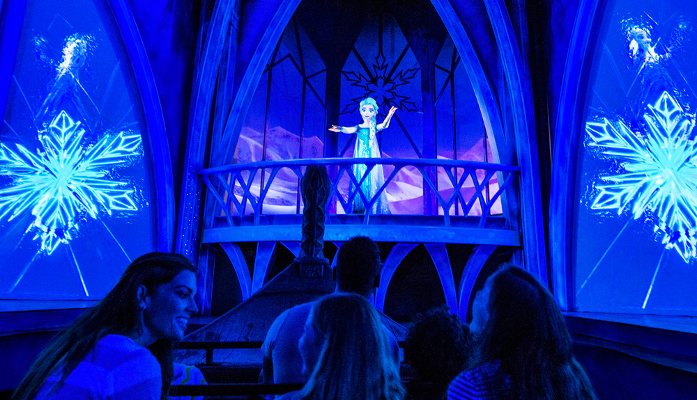 Frozen Disney character is seen on stage during a live performance as an audience watches