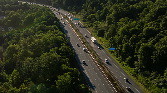 An aerial view above Highway 403 on the Hamilton mountain on sunny morning, the growing Hamilton skyline seen in the distance, the Canadian industrial city is on the shores of Lake Ontario.