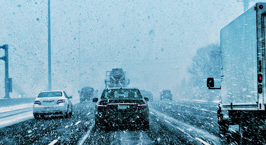 Drivers view of a severe snowstorm on the freeway in traffic