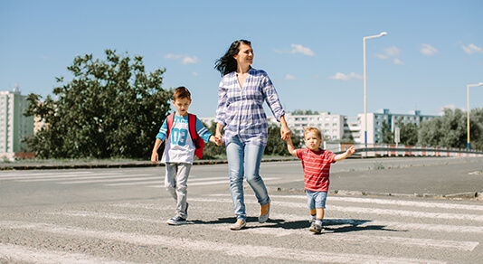 Mother and children crossing a pedestrian cross walk