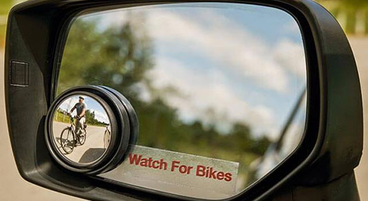 A side mirror with the CAA Watch for Bikes decal