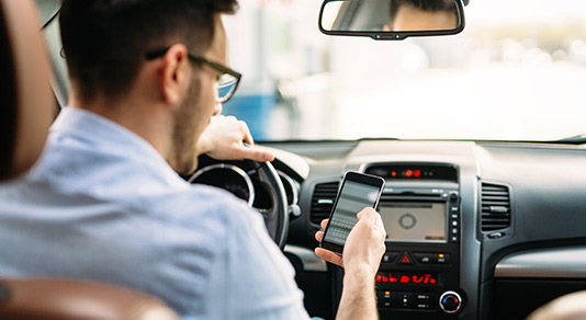 Man on his phone texting while driving