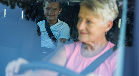 Grandmother driving grandson