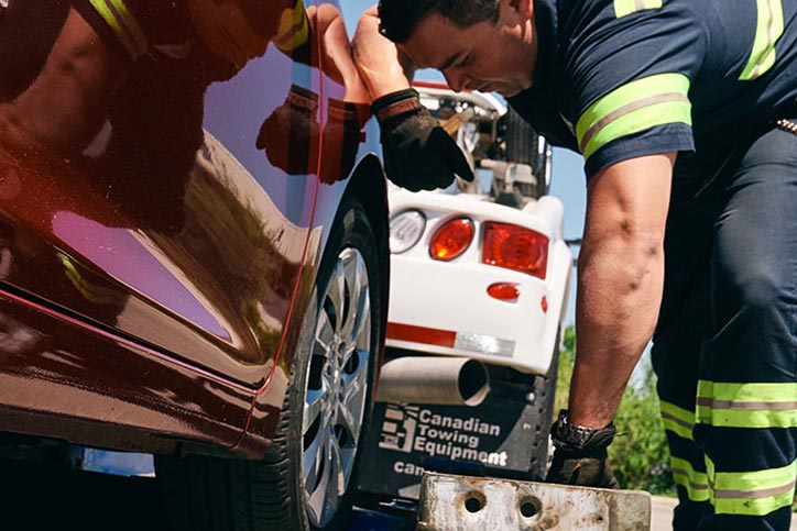 Tow truck driver working on side of road