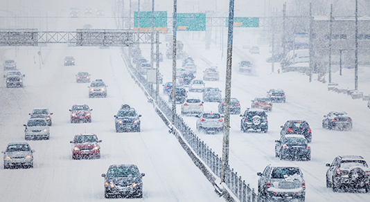 Snowstorm on busy highway during rush hour