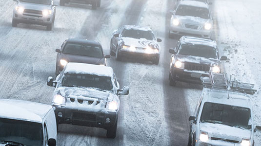 Cars on a highway during a snowstorm