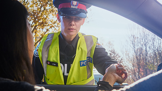 Police officer checking driver's license.