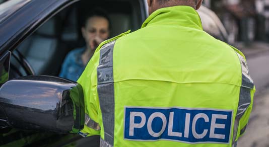 Police officer pulling over driver