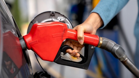 Image of gas pump handle inserted into the car