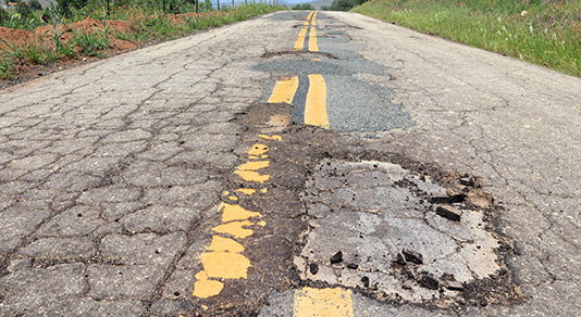Pot hole on an empty road