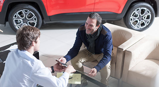 A man inside a car dealership.