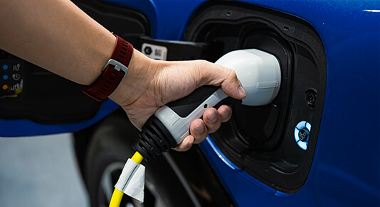 Hand holding electric car charger