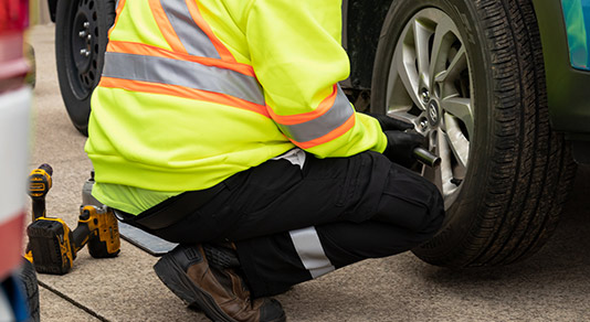 Mechanic fixing car tire