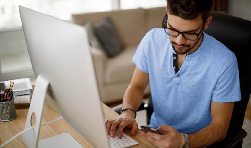 Young man using mobile phone at home